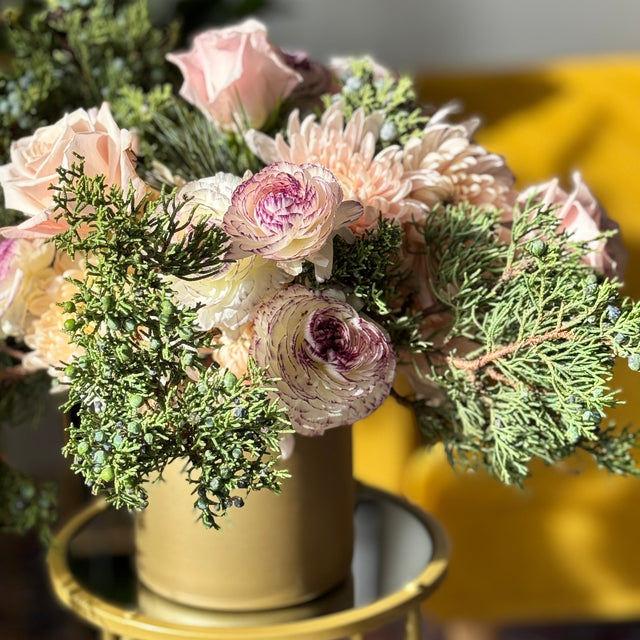 Soft pink holiday flower arrangement designed by a florist in Springfield Virginia
