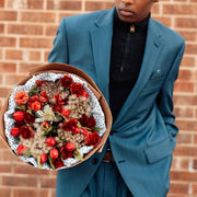 Bouquet of red flowers held by a man