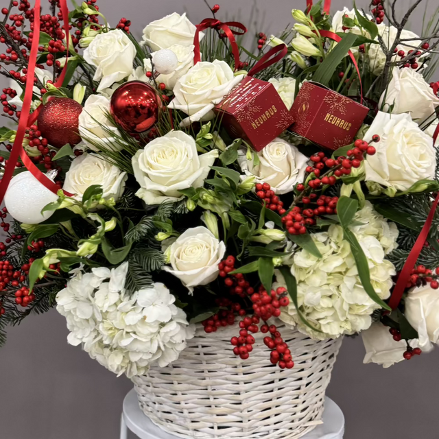 Gorgeous white basket with white and red flowers. 