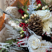 Winter vibe bouquet with pinecones and ilex.