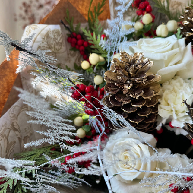 Winter vibe bouquet with pinecones and ilex.