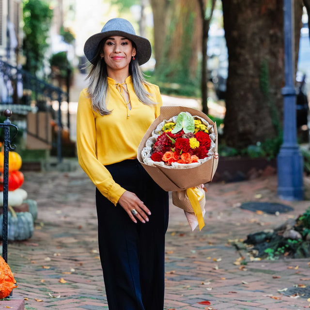 Bright flower bouquet in the arms of a woman.