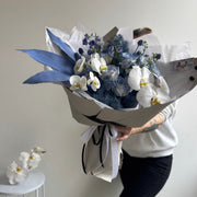 Delicate blue and white flowers in a designer arrangement