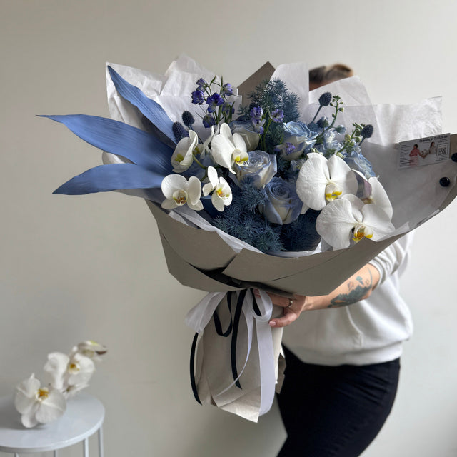 Delicate blue and white flowers in a designer arrangement