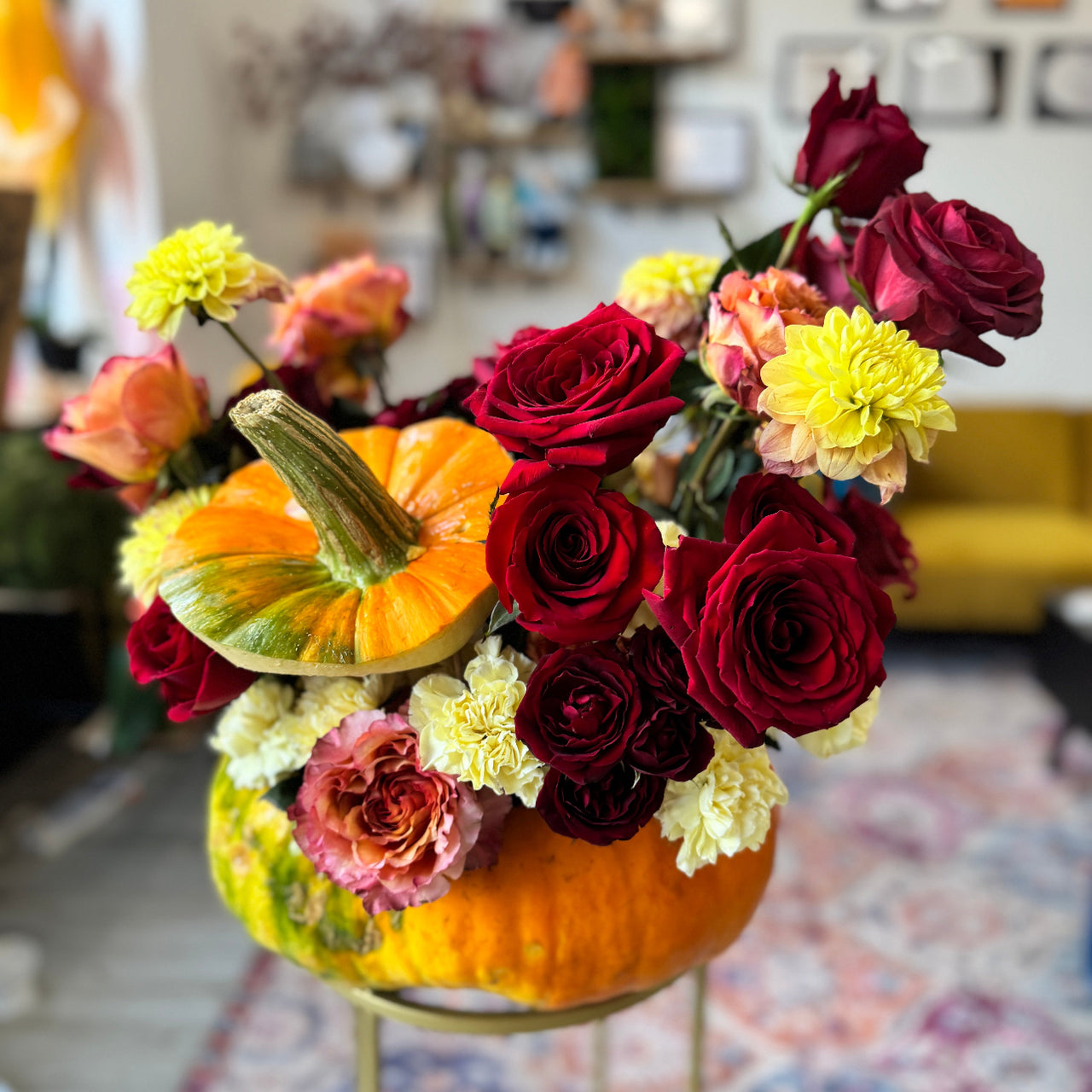 Eco-friendly fall floral arrangement in a natural pumpkin base