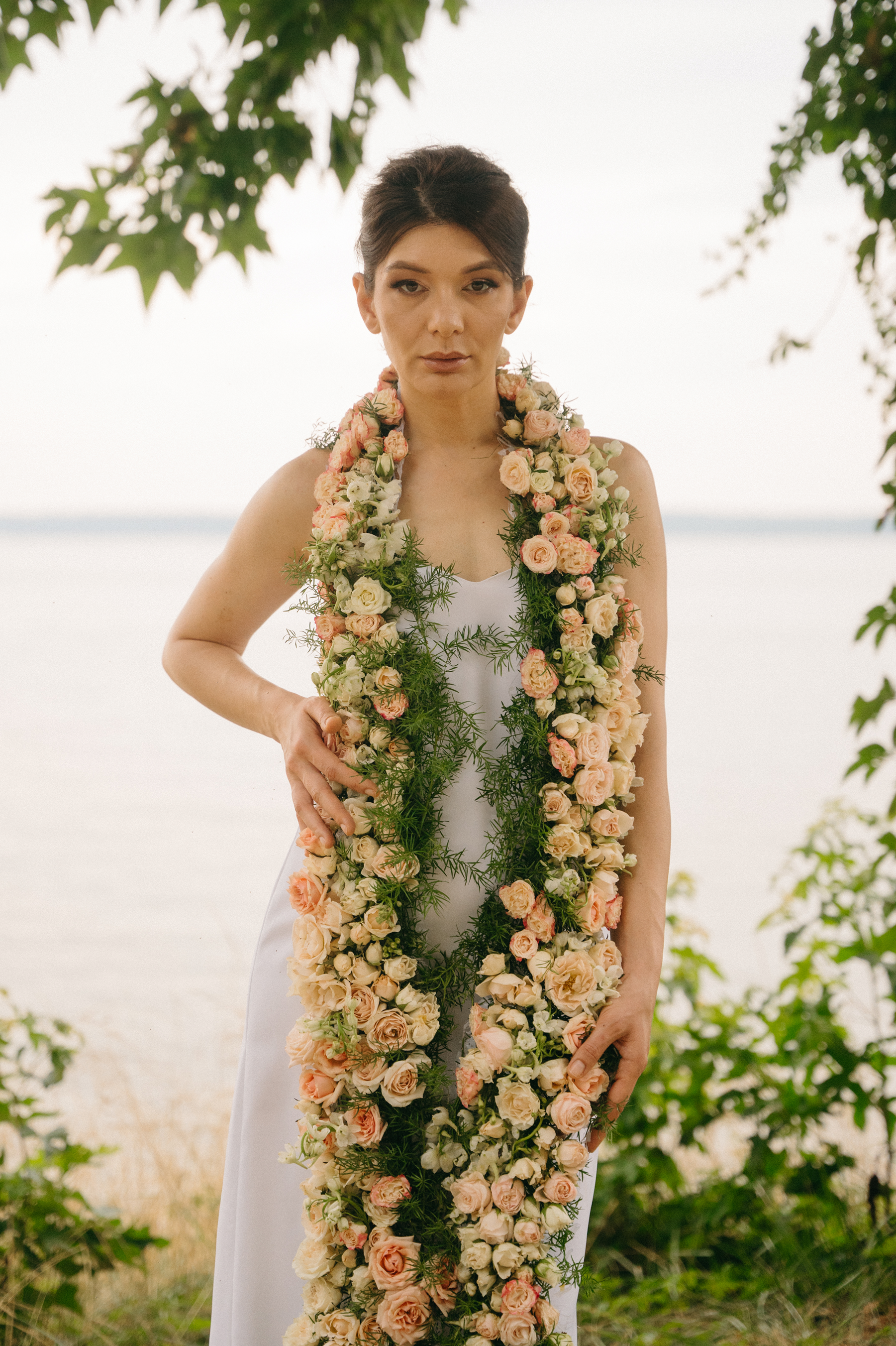 Woman wearing a floral garland in a natural setting