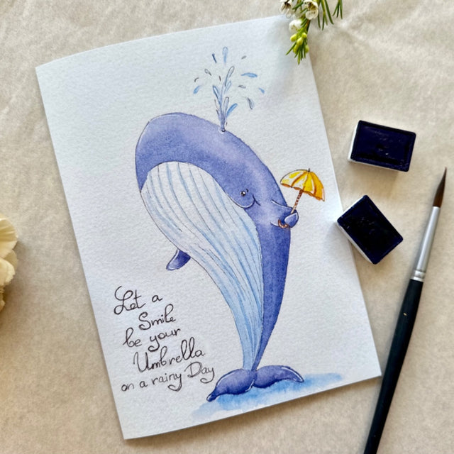 Card with text "Let a smile be your umbrella on a rainy day"