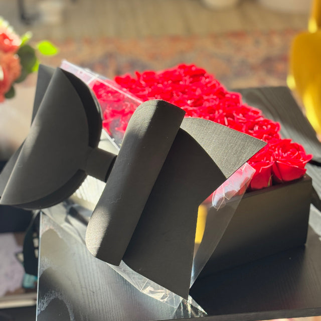 Red roses arranged in a luxury black box