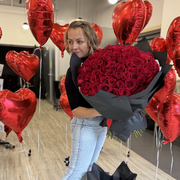 Elegant oversized red rose bouquet with sleek black paper
