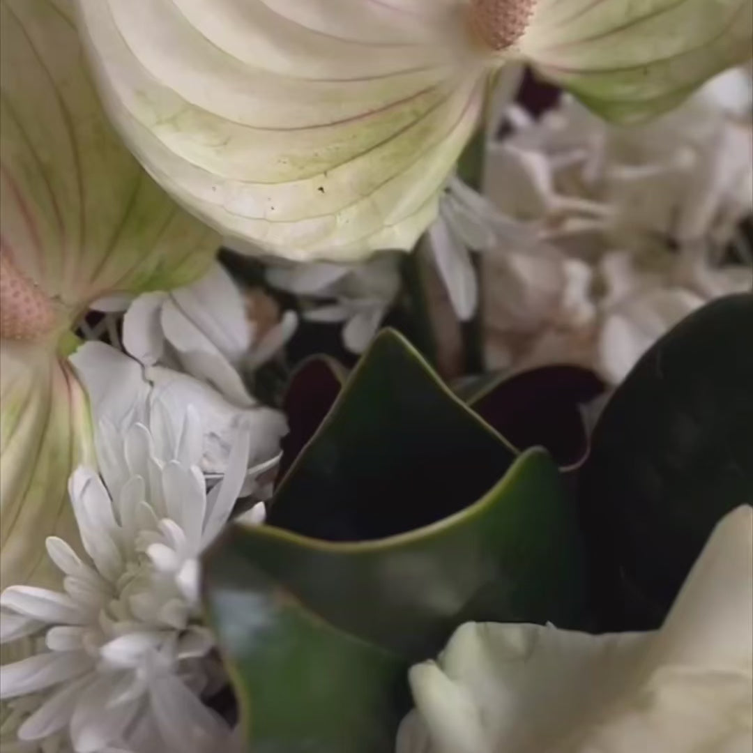 Luxurious white Winter Grace centerpiece, a perfect floral accent for festive dinners and elegant gatherings.