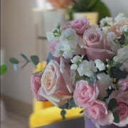 Pastel pink rose arrangement styled in a modern glass vase