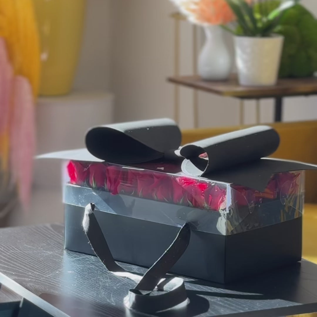 Romantic red roses displayed in a sleek black presentation box