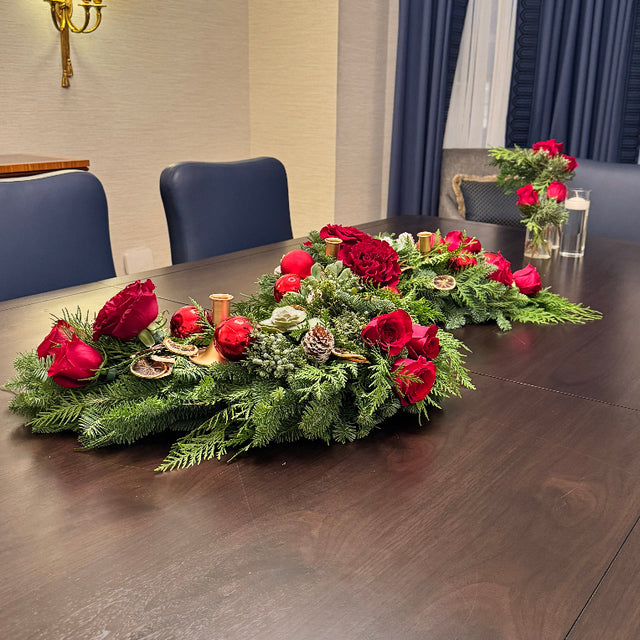 Modern Evergreen Table Centerpiece in sculptural S-shape with mixed evergreens and candle spaces