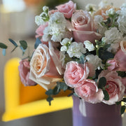 Pink Muse arrangement featuring roses and eucalyptus in a glass vase