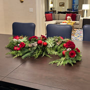 Luxury evergreen table centerpiece with red roses in water tubes and natural textures