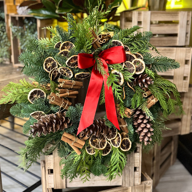 holiday wreath with lemons and pinecones 