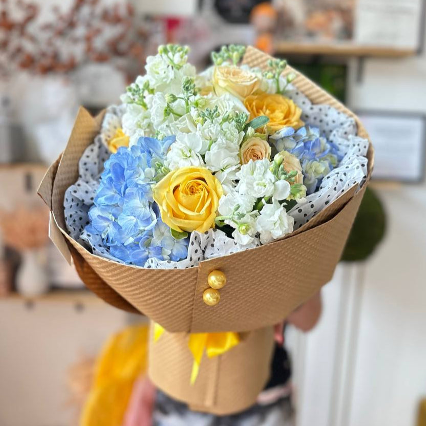 Blueberry Sunshine bouquet with roses, hydrangea, and stock flowers